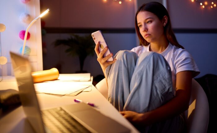 Anxious teen girl on her smartphone